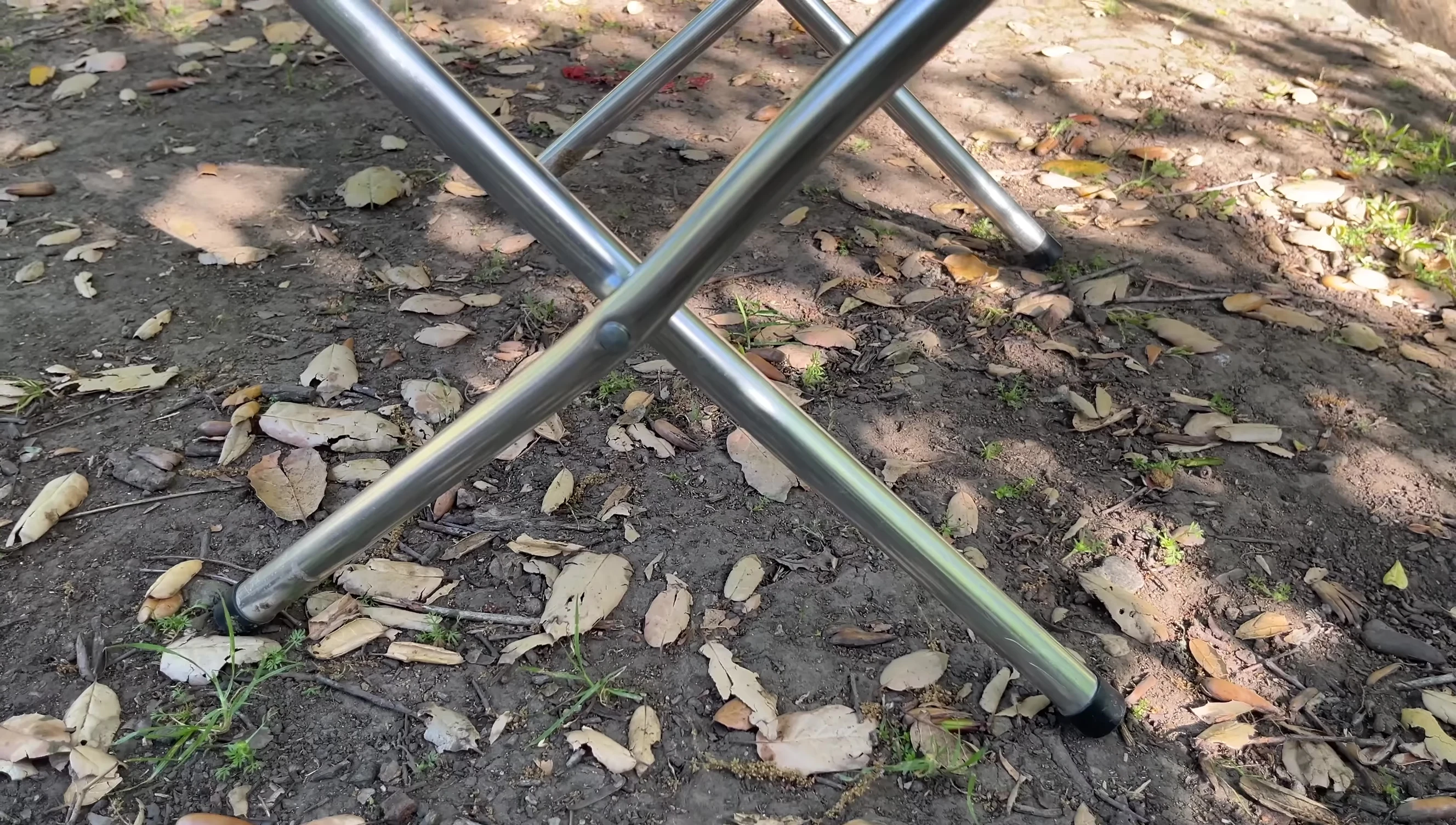 Person using the camp stool for cooking.