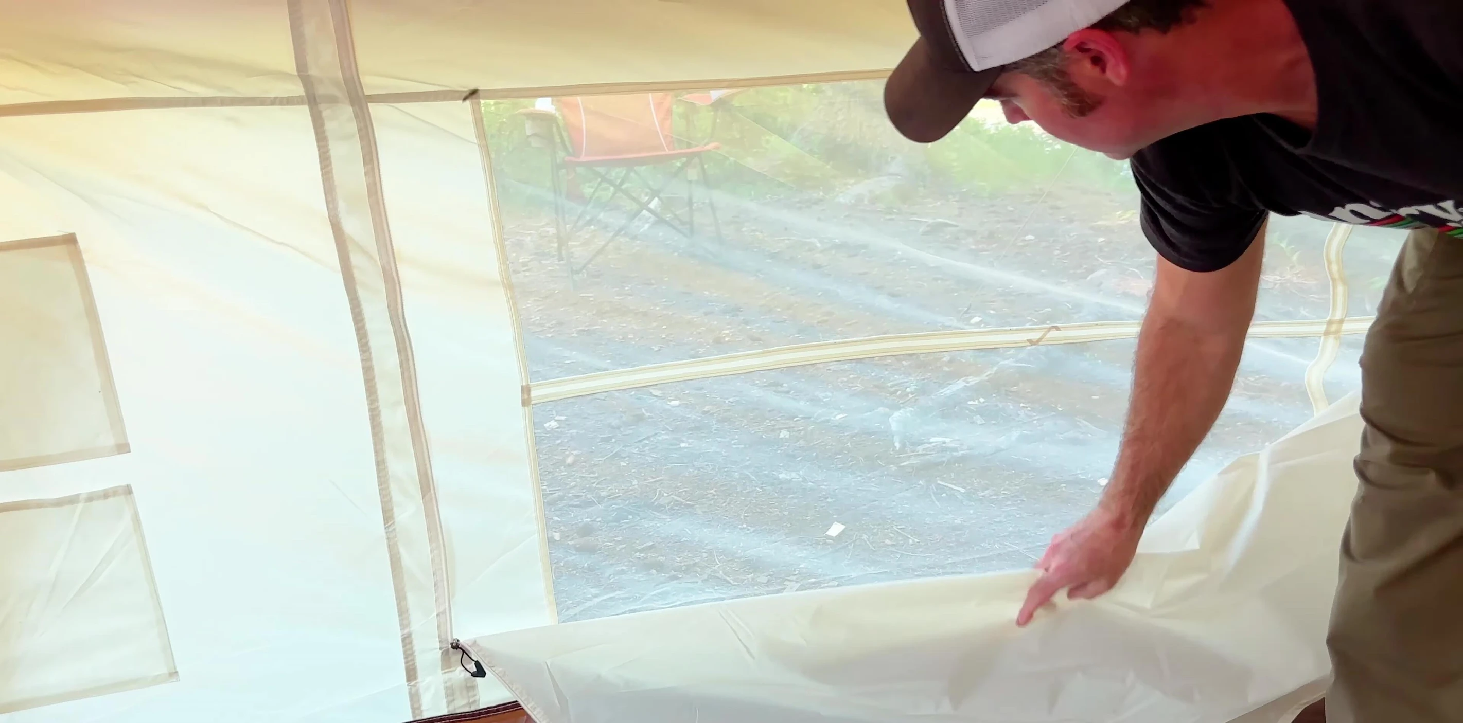 The reviewer standing inside the tent to show the headroom.