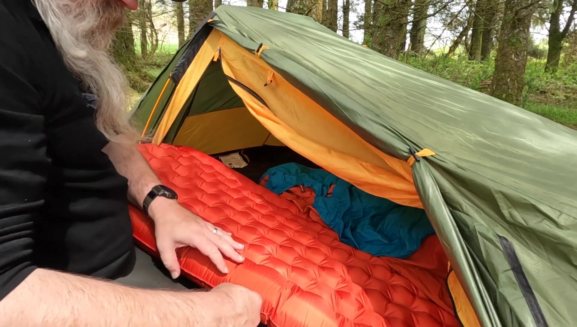 A shot of the reviewer assembling parts of the sleeping system