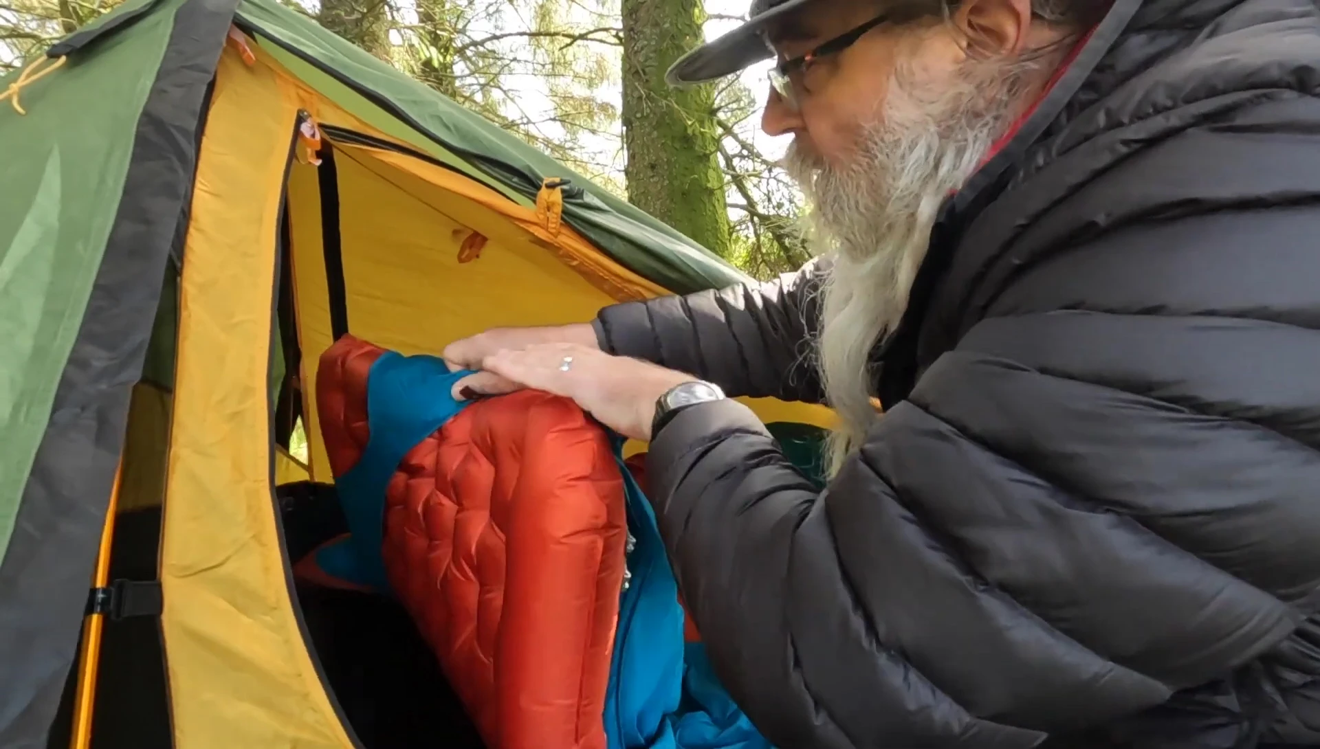 The reviewer discussing the size and fit of the sleeping system.