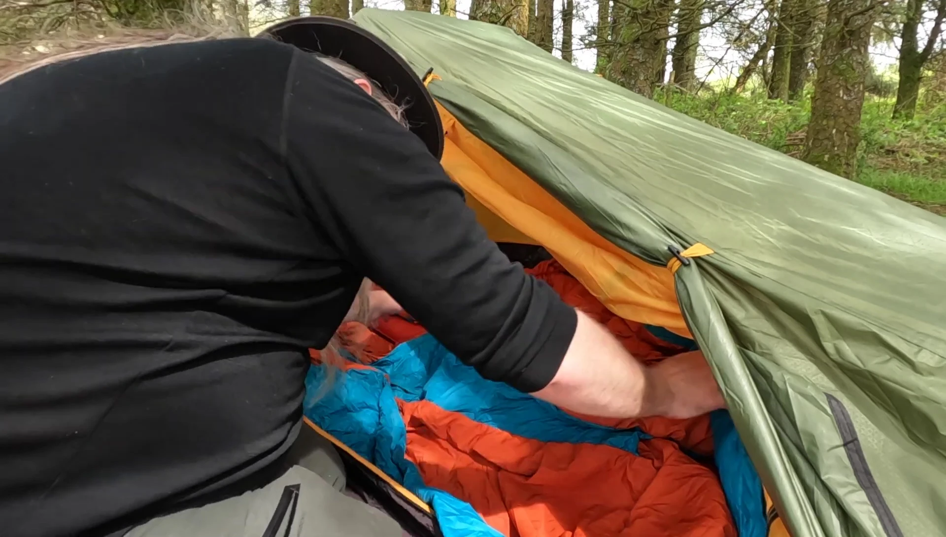 The reviewer displaying the quilt and mats of the Zenbivy Trek system.