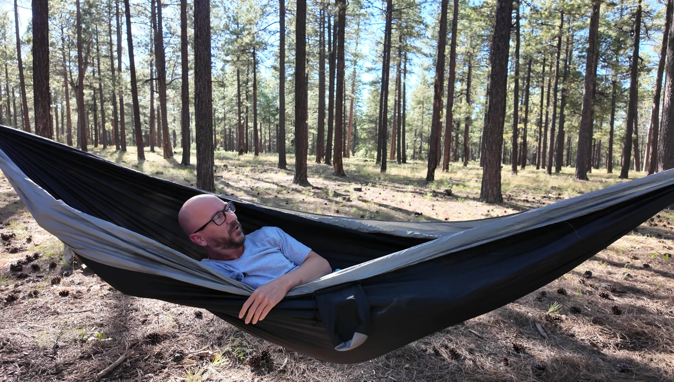 Person comfortably lounging in the Wise Owl hammock, showcasing its ample space.