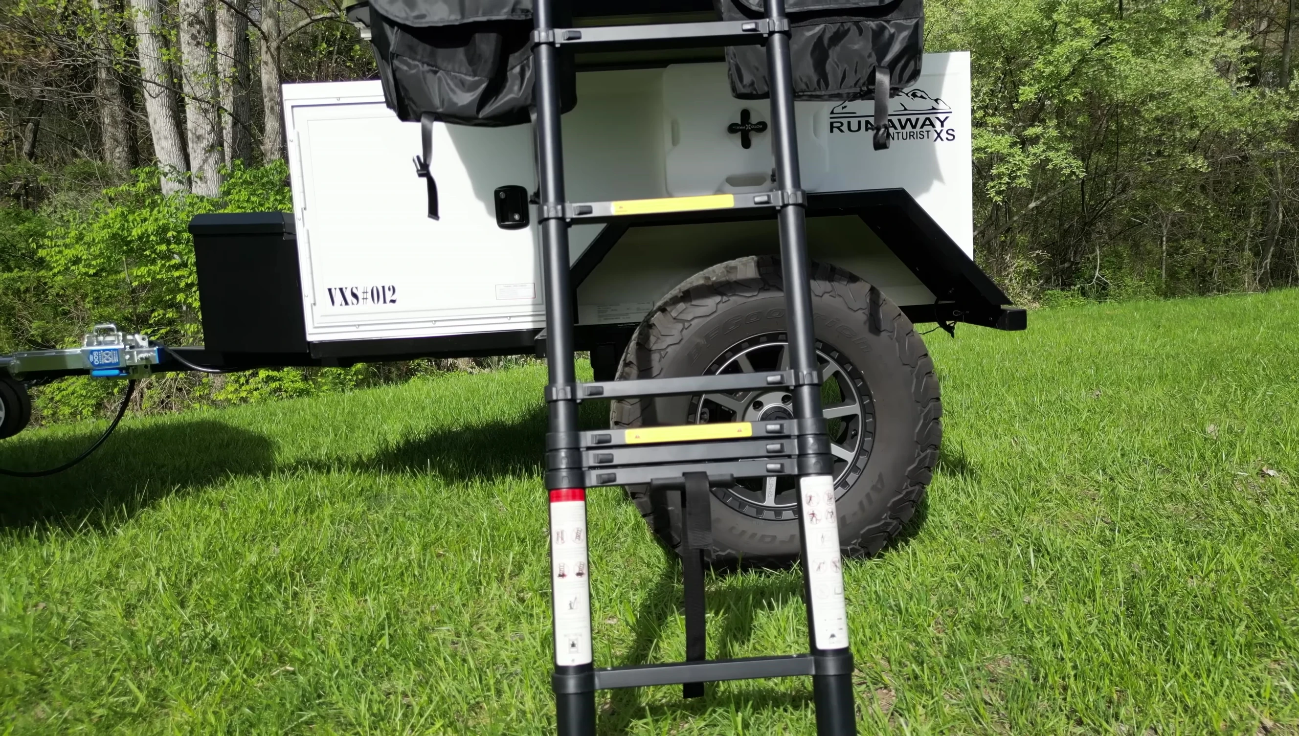 The fully opened tent with ladder and awnings extended.