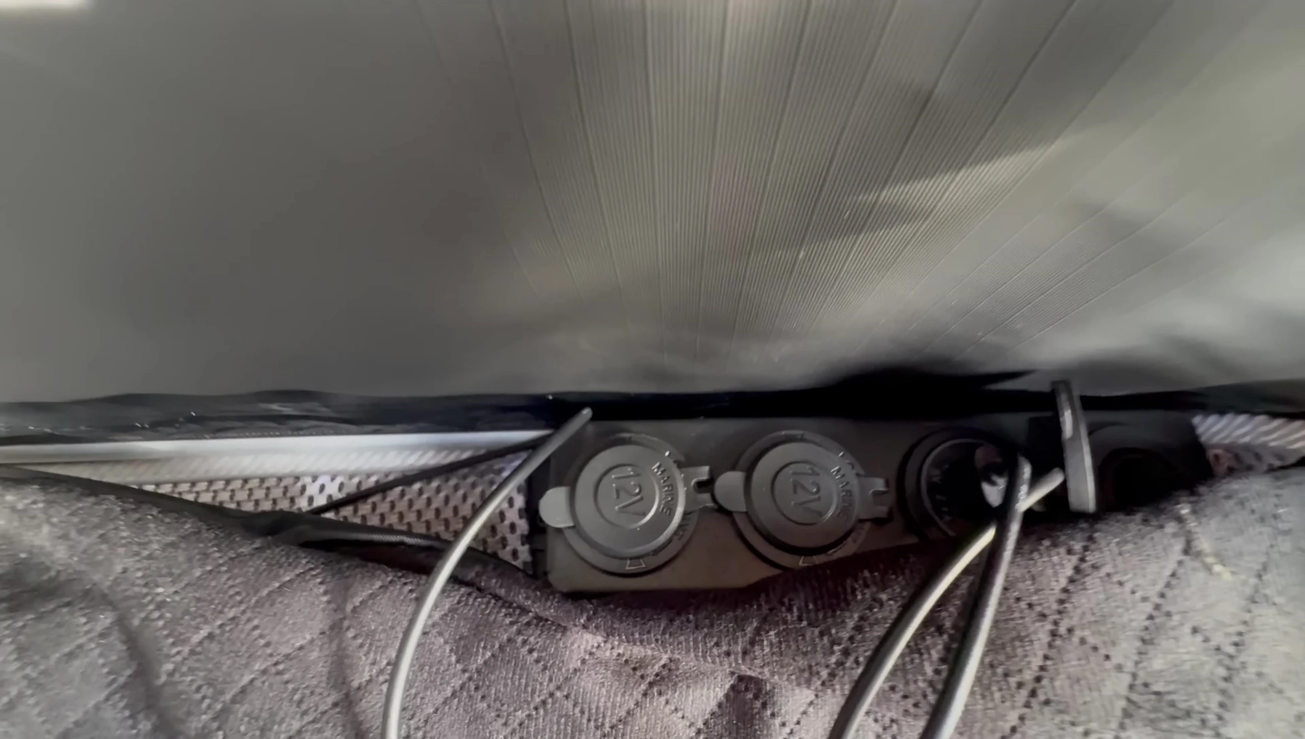 The 12V power outlet and USB ports.