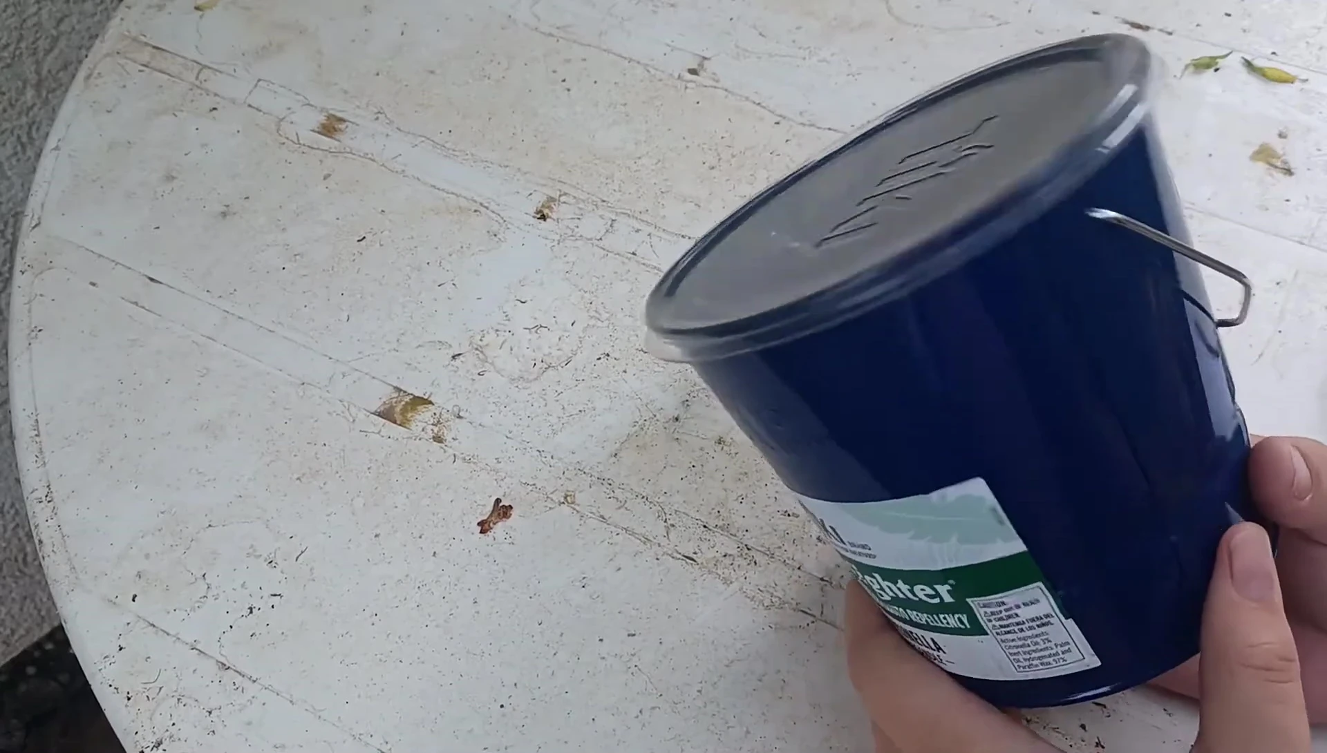 Close-up of the TIKI BiteFighter candle in its blue container