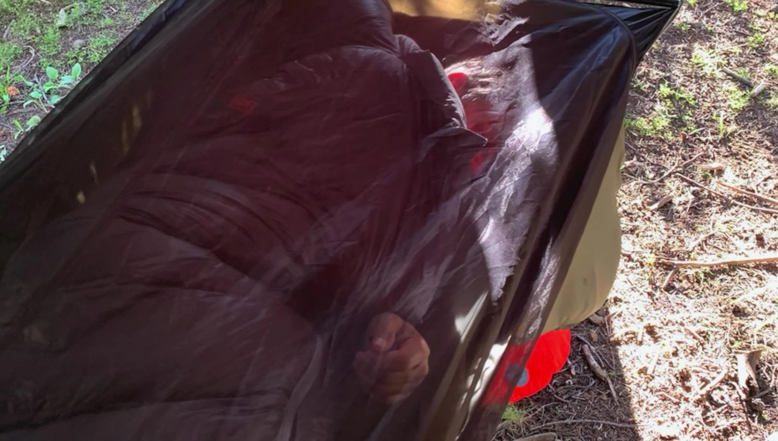 Person sleeping comfortably in the hammock