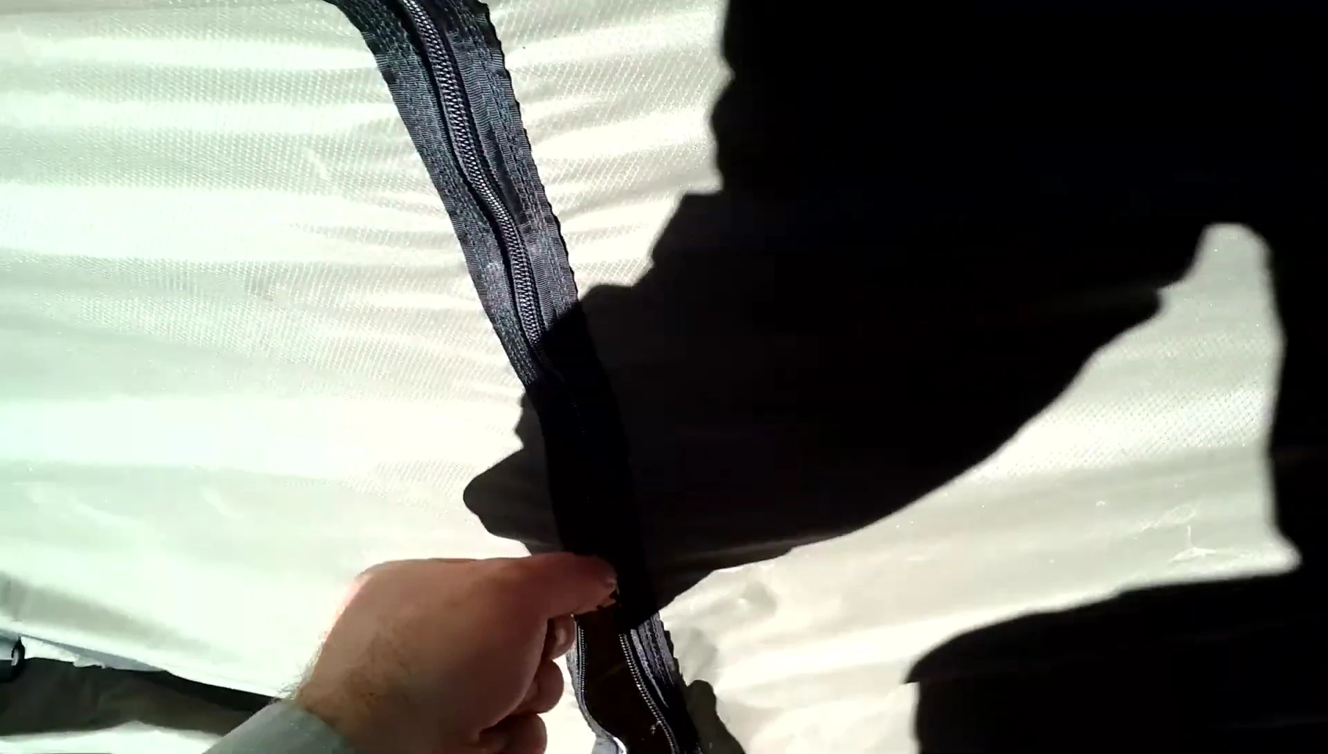 Interior of the wall tent showing cots and a blue tarp