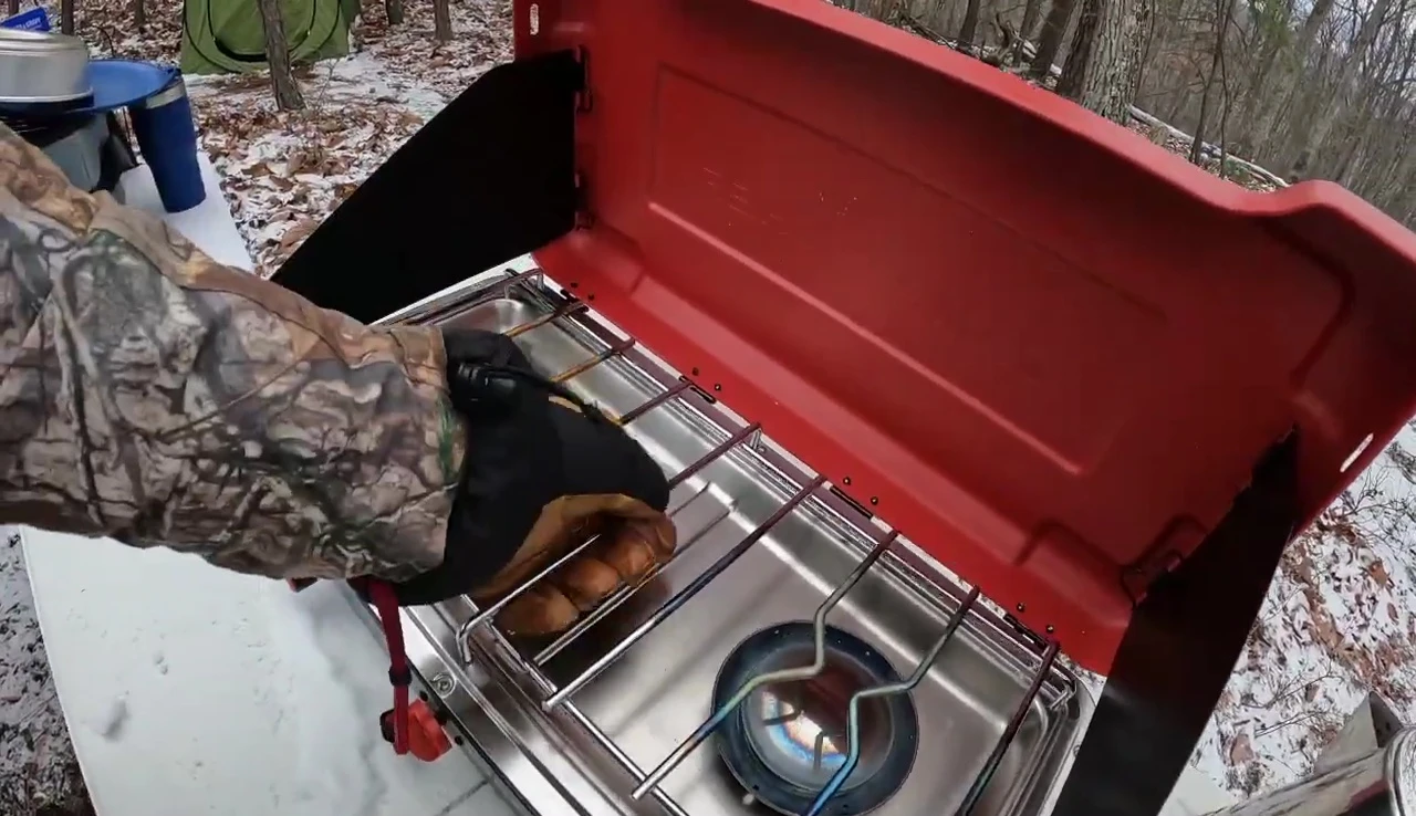 Close up of the grill being lifted out of the stove
