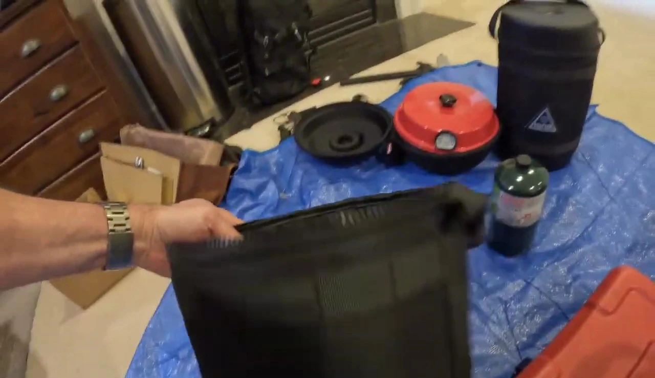 The larger propane tank in its padded case