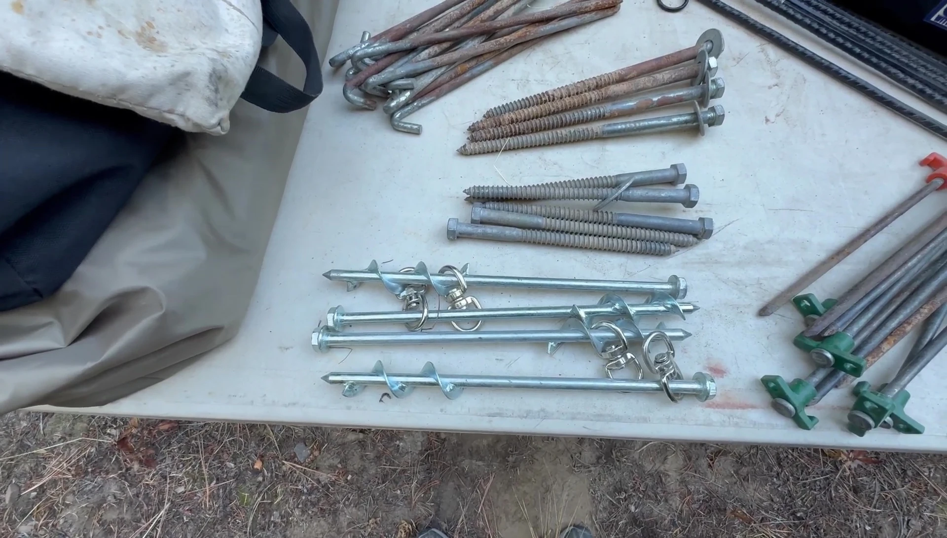 Screw stakes being driven into the ground.