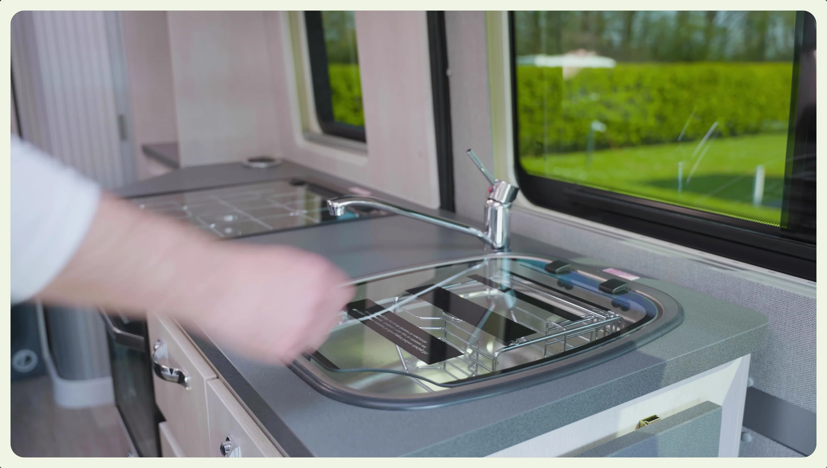 The glass sink cover with a built-in drainer.