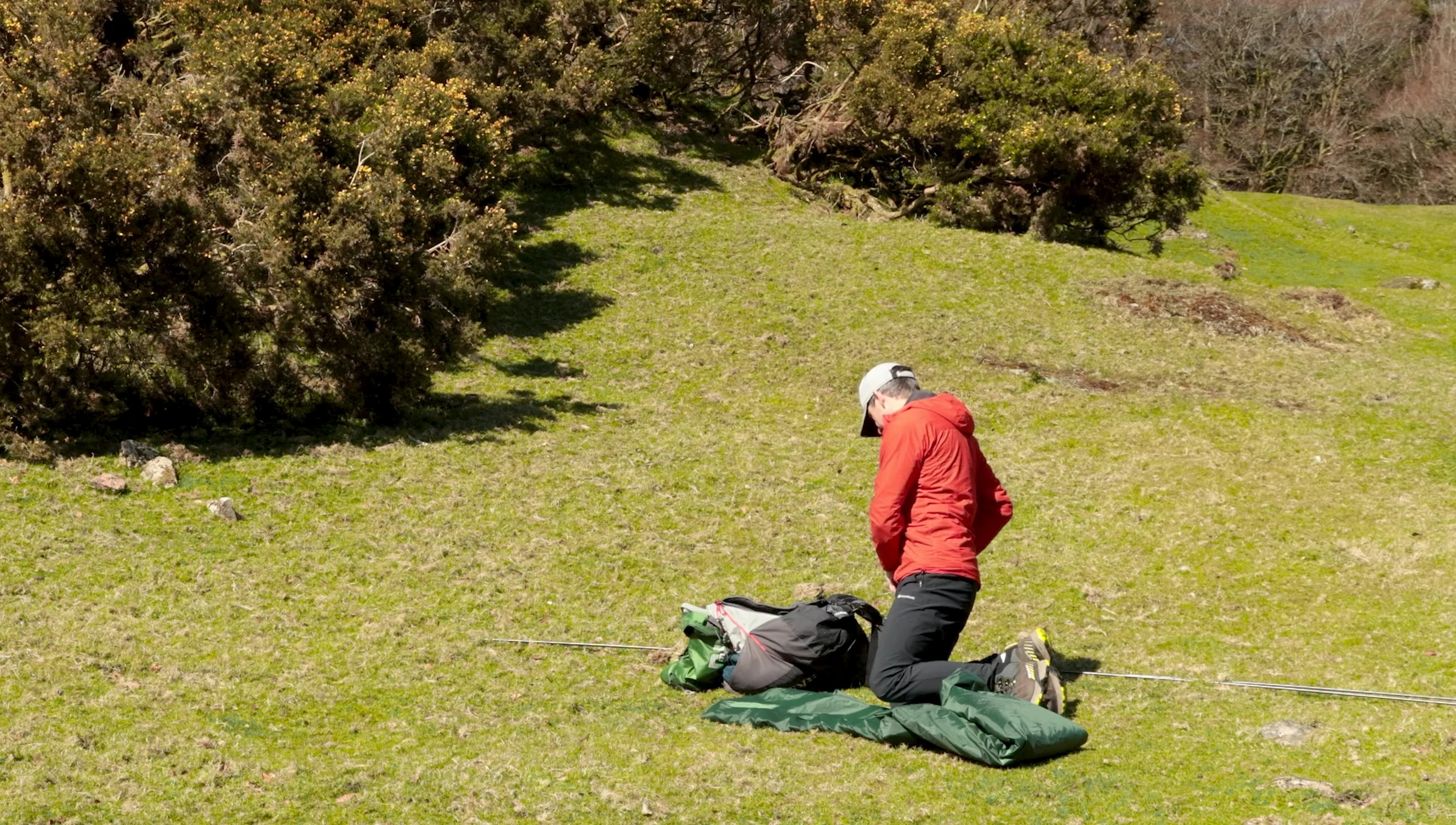 The reviewer is in the process of pegging out the tent.