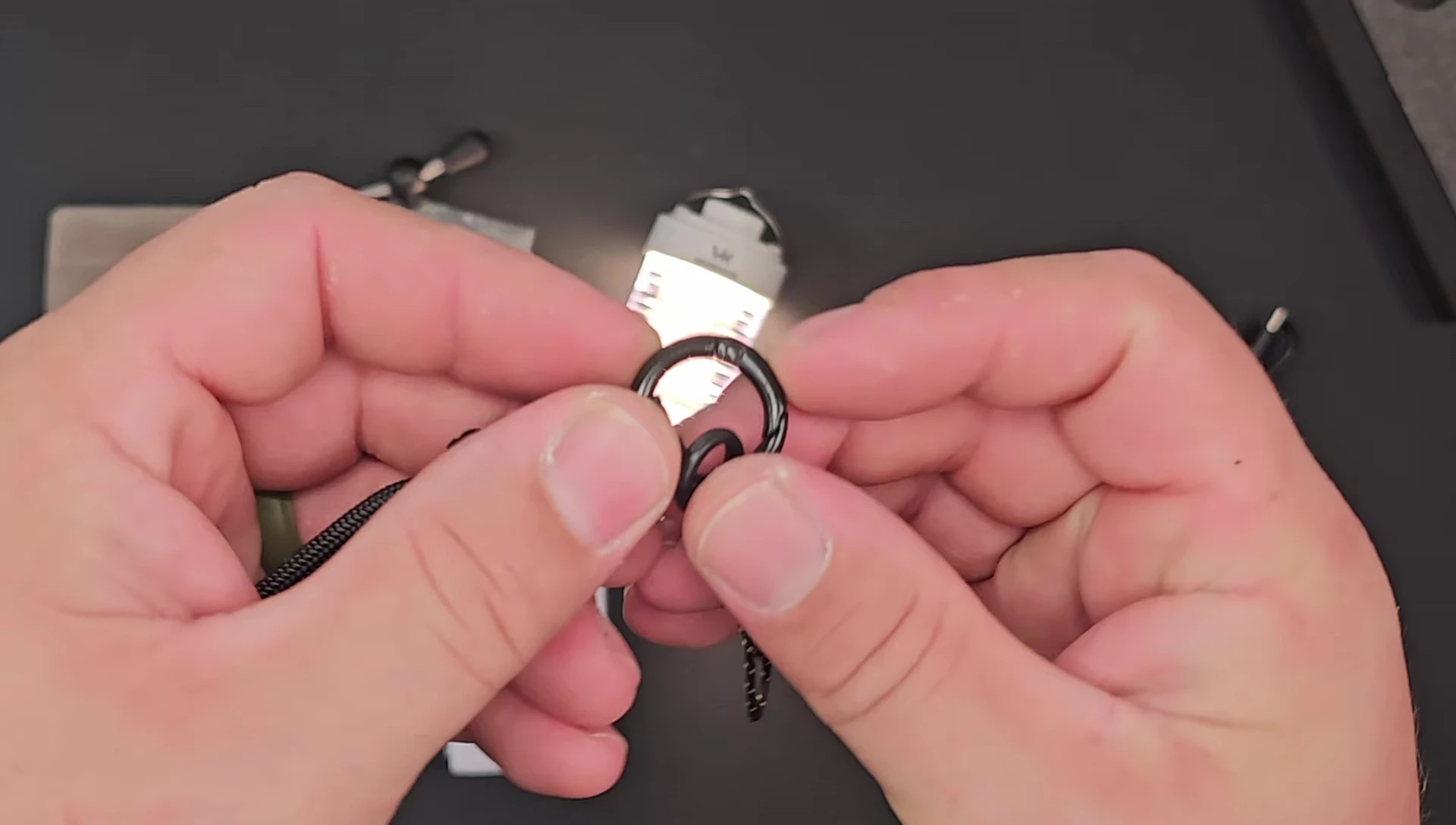 The Wurkkos CL01 lantern displayed with its clip and lanyard.