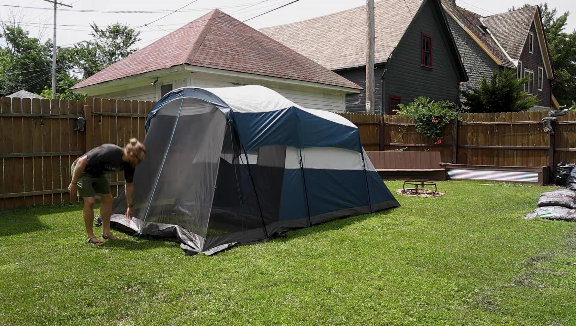 The rainfly being placed over the tent.