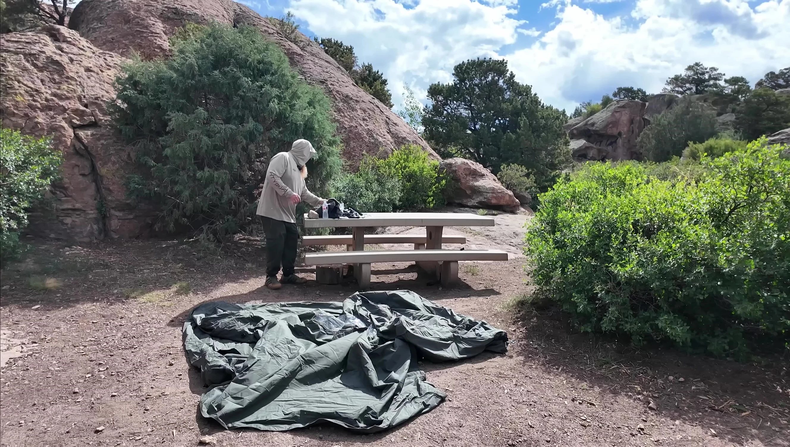 The reviewer beginning to inflate the tent with the hand pump.