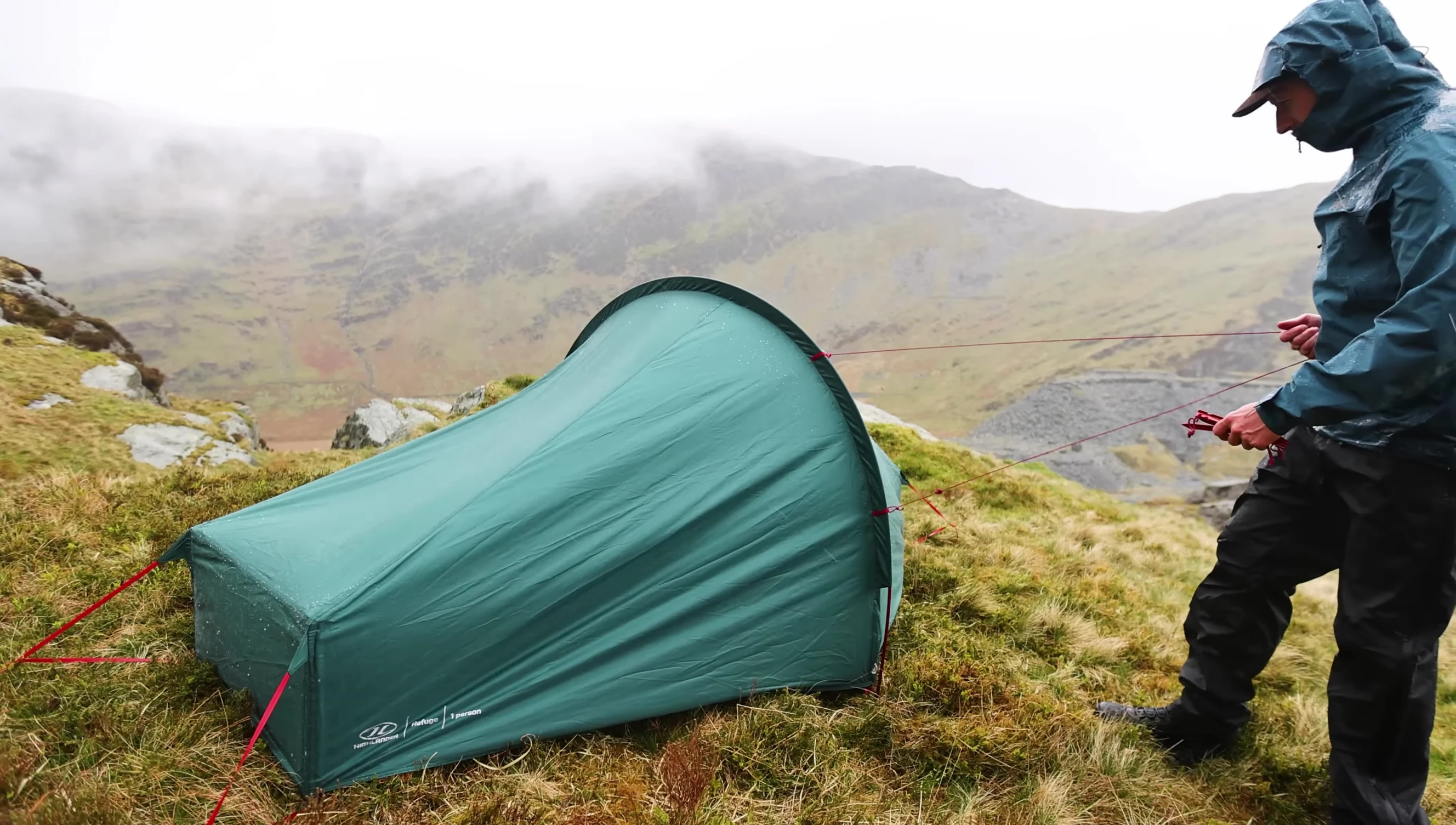 The reviewer demonstrating the ease of packing the tent away with the corner poles still attached.