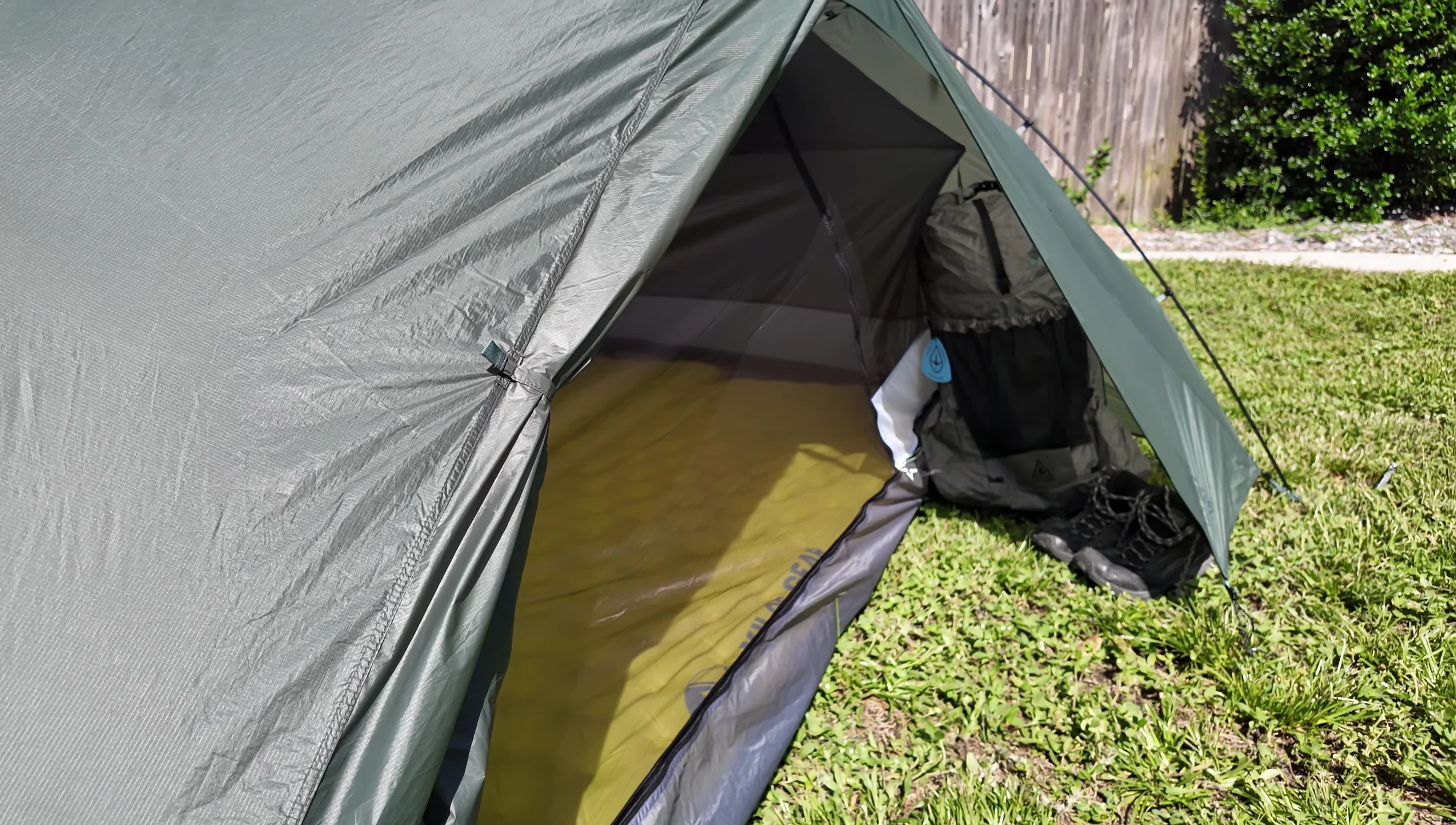 View of the overhanging doors and low-extending fly, highlighting their rain protection features.
