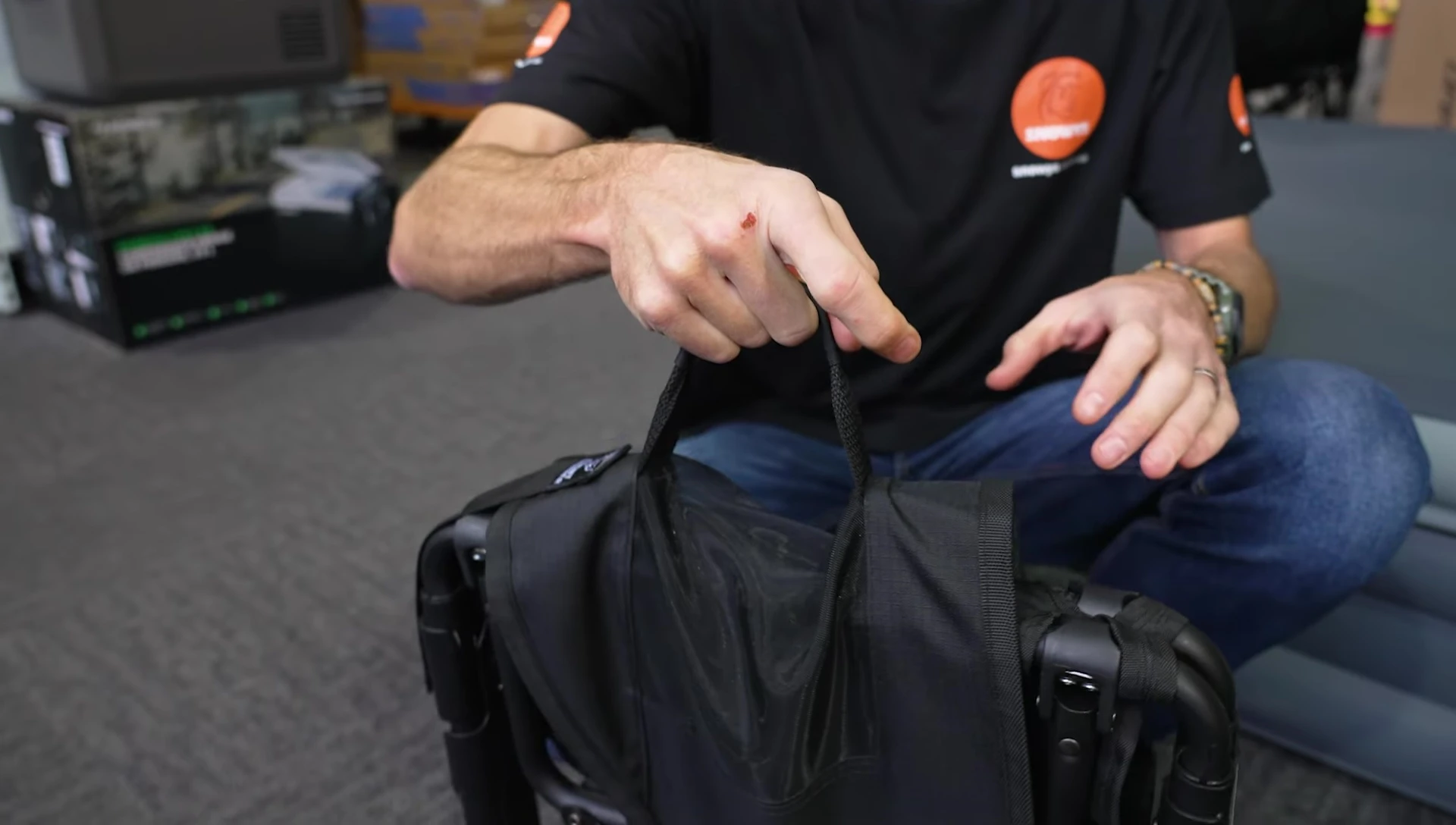 The chair showing Velcro straps before unfolding.